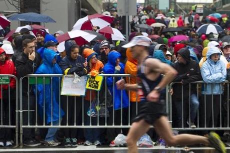 Soaked spectators lined a rainy, cold Boylston Street in Boston, near the finish of last year?s marathon.
